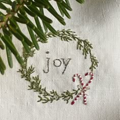 a christmas ornament with the word joy embroidered on it