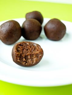 a white plate topped with chocolate balls on top of a green and yellow tablecloth