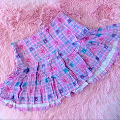 New Care Bears X Dolls Kill Plaid Skirt In A Rose Pink With Baby Blue, Pink, And White Plaid. Bears And Cherries Scattered Throughout. Wide Waist Band To Snatch The Tummy. Side Zip. Made Of 100% Viscose Which Feels Like Rayon Crepe. Light Weight And Cool Fabric Is Perfect For Spring/Summer. This Piece Has No Stretch! Small Waist Is 14” Laying Flat *No Offers - Price Is Final Cute Cotton Skirt With Floral Print, Cute Cotton Mini Skirt With Ruffles, Playful Pink Bottoms For Spring, Cute Mini Skort With Lined Skirt, Cute Mini Length Lined Skort, Cute Summer Mini Skirt, Cute Pink Spring Bottoms, Cute Cotton Skirt, Cute Pleated Mini Skirt