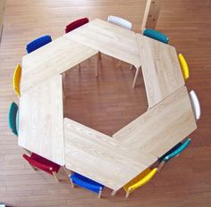 an overhead view of a children's table with chairs around it on the floor