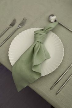 a white plate topped with a green napkin