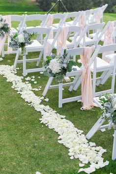 the aisle is lined with white flowers and greenery for an outdoor wedding ceremony at stoneridge country club