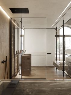 the interior of a modern bathroom with glass walls and wood flooring, along with large windows