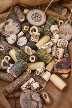 a bag filled with lots of different types of beads and pendants on top of a piece of cloth