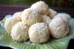 a green plate topped with sugar covered donuts