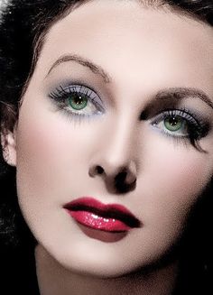 a woman with green eyes and red lipstick