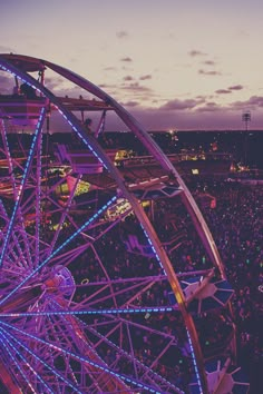 the ferris wheel is lit up at night