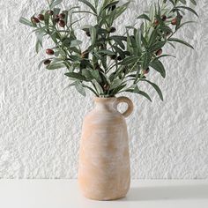 a vase that has some plants in it