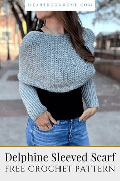 a woman wearing a blue sweater with text overlay that reads, delphine sleved scarf free crochet pattern