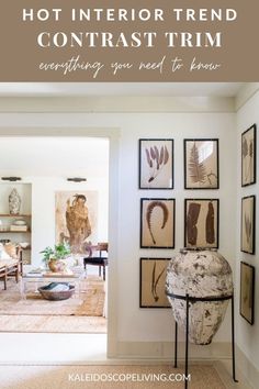 a living room filled with furniture and pictures on the wall next to an open door