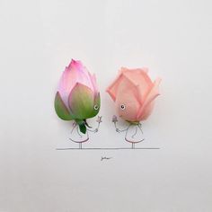 two pink flowers with faces drawn on them