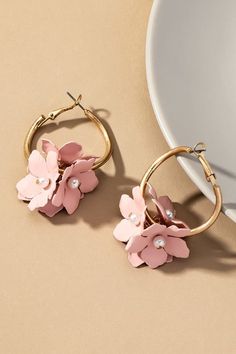 Color coated flower cluster hoop earrings. Size: 1.5" x 2.0" Materials: Base Metal and Matte Gold Plated Pink Metal Earrings For Spring, Chic Small Hoop Earrings For Spring, Spring Flower Shaped Jewelry With 3d Flowers, Flower Shaped Metal Jewelry For Spring, Small Hoop Pink Flower Earrings, Floral Metal Jewelry For Spring, Spring Flower Shaped Metal Jewelry, Spring Rose Gold Pierced Earrings, Trendy Hoop Earrings With Flower Charm For Spring