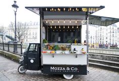 a food cart parked on the side of a street