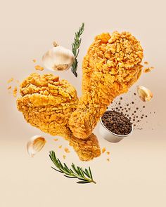 an image of fried chicken with spices and seasoning next to garlic on a white background