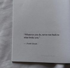 an open book with a quote on it sitting on top of a white bed sheet