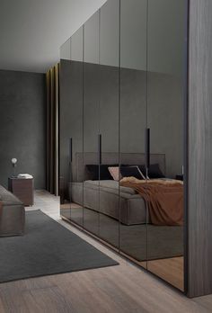 a bedroom with mirrored walls and furniture in it