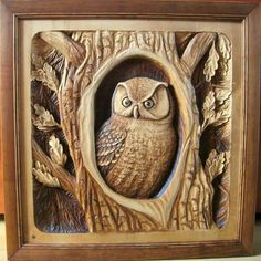 an owl carved into the side of a wooden frame