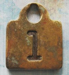 an old rusty padlock with the letter i on it