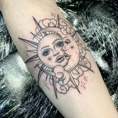 a sun and moon tattoo on the arm