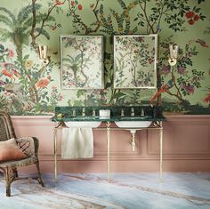 a bathroom with two sinks and a chair in front of the wall covered in floral wallpaper