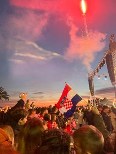 the crowd is watching fireworks go off in the sky