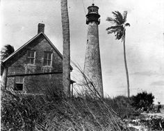 an old black and white photo of two lighthouses on the beach with palm trees