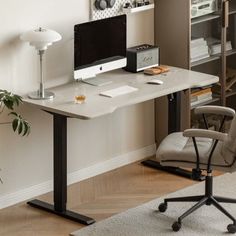 a desk with a computer on it in a room