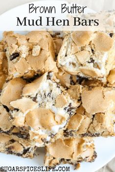 brown butter mud hen bars stacked on top of each other in a white plate