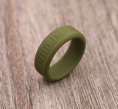 a green rubber ring sitting on top of a wooden table