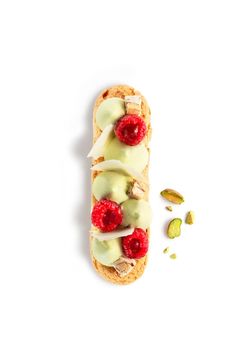 a sandwich with raspberries, cucumber and pistachio on it