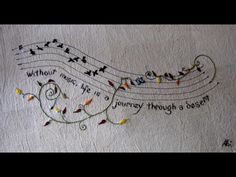 a piece of paper with writing on it and music notes in the middle, surrounded by tiny lights