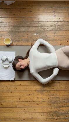 a woman laying on top of a yoga mat