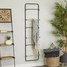 a living room with two shelving units and a clock on the wall next to it