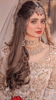 a woman wearing a bridal gown and jewelry