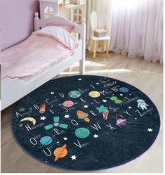 a child's room with a bed and rug that has space themed letters on it