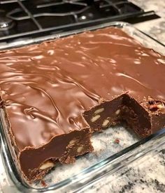 a chocolate cake is cut in half and sitting on a counter