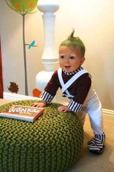 a little boy that is sitting on top of a ottoman