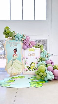 the princess and the frog birthday party is complete with balloons, grapes, and decorations