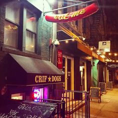 the entrance to an eatery with neon lights and graffiti written on it's doors