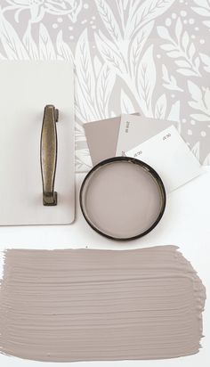 the paint is being used to create an elegant wallpaper pattern with white and gray colors