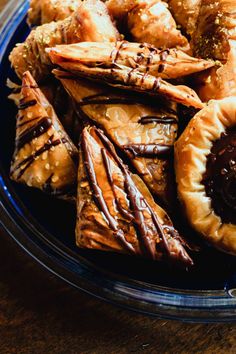 a blue plate topped with pastries on top of a wooden table