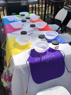 the table is set up with colorful plates and bowls on it, ready to be served