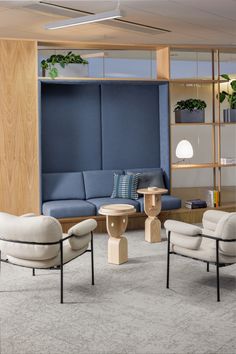 a living room filled with furniture next to a wooden book shelf and shelves on the wall