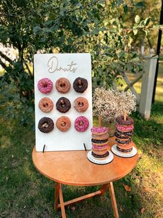 donuts on display in front of a sign with flowers