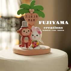 a wedding cake topper with an animal and monkey figurine