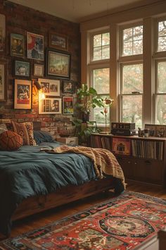 a bedroom with a brick wall and lots of pictures on the walls, along with a bed