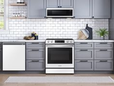 a kitchen with gray cabinets and white appliances