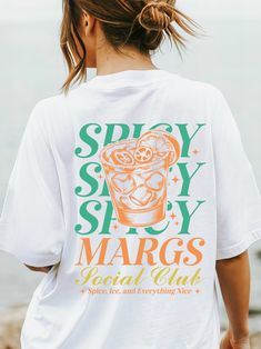 Try not to love this classic unisex t-shirt with your favorite cocktail designs! 🍹 ✨ Made with medium fabric consisting of 100% cotton for year-round comfort that is sustainable and highly durable.  ✨ The classic fit of this shirt ensures a comfy, relaxed wear while the crew neckline adds that neat, timeless look that can blend into any occasion, casual or semi-formal. ✨ The tear-away label means a scratch-free experience with no irritation or discomfort whatsoever. ✨ Made using 100% US cotton Etsy Tee Shirts, Trendy Tees For Women, Festival T Shirt Design, Club Tshirt Designs, T Shirt Design Aesthetic, Club Shirt Designs, Cloud 9 Aesthetic, Trending T Shirt Designs, Tshirt Design Ideas Trendy