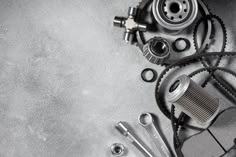 an overhead view of a motorcycle engine and gear on concrete background with space for text