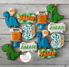 decorated cookies are arranged in the shape of dinosaurs and names for each cookie item